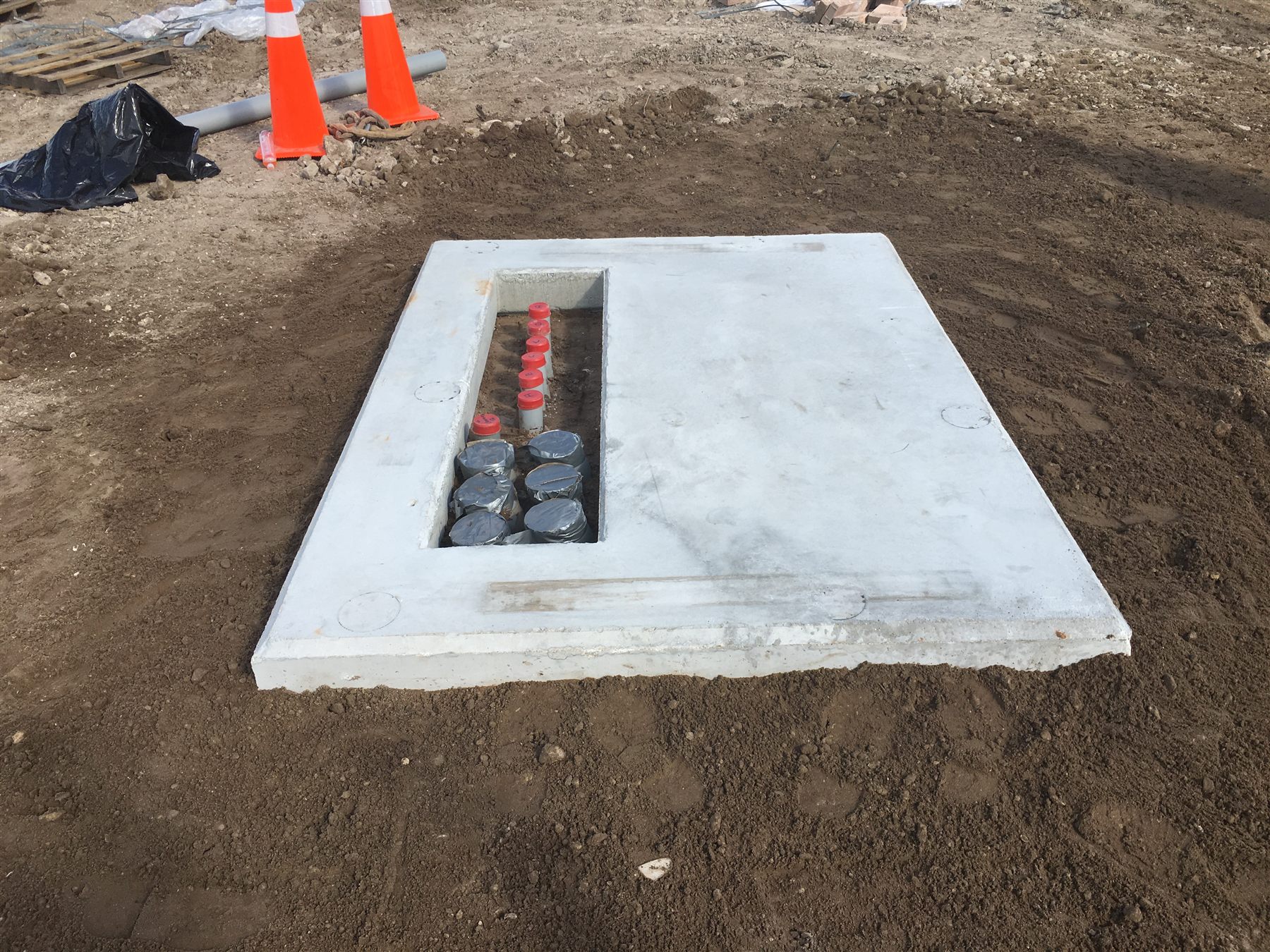 Underground utility handhole installation and conduit coordination
