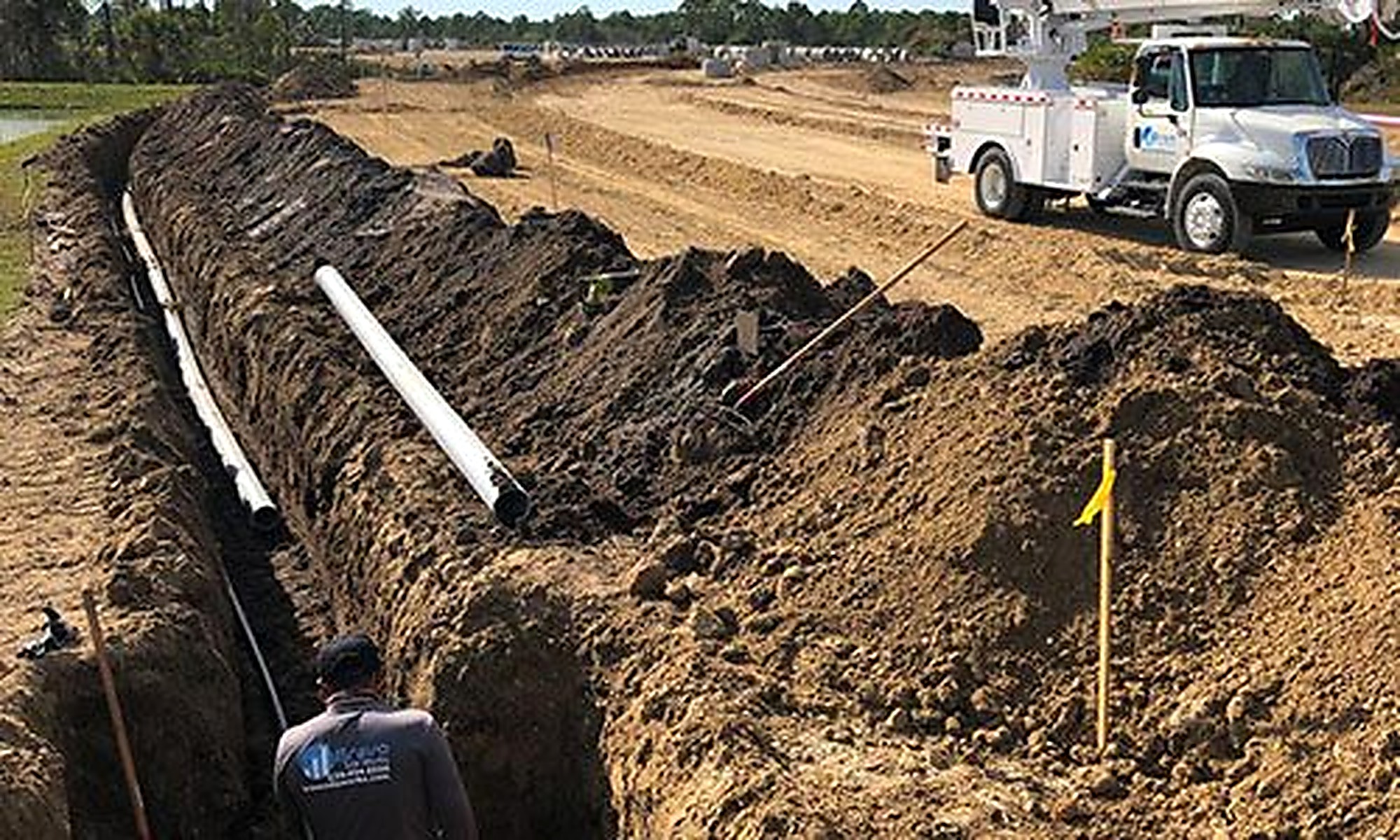 Prepared utility trench with pipe awaiting backfill